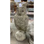 A reconstituted stone garden ornament modelled as a standing owl, height 71cm