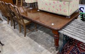 A Victorian mahogany extending dining table on turned legs, length 302cm extended (two spare