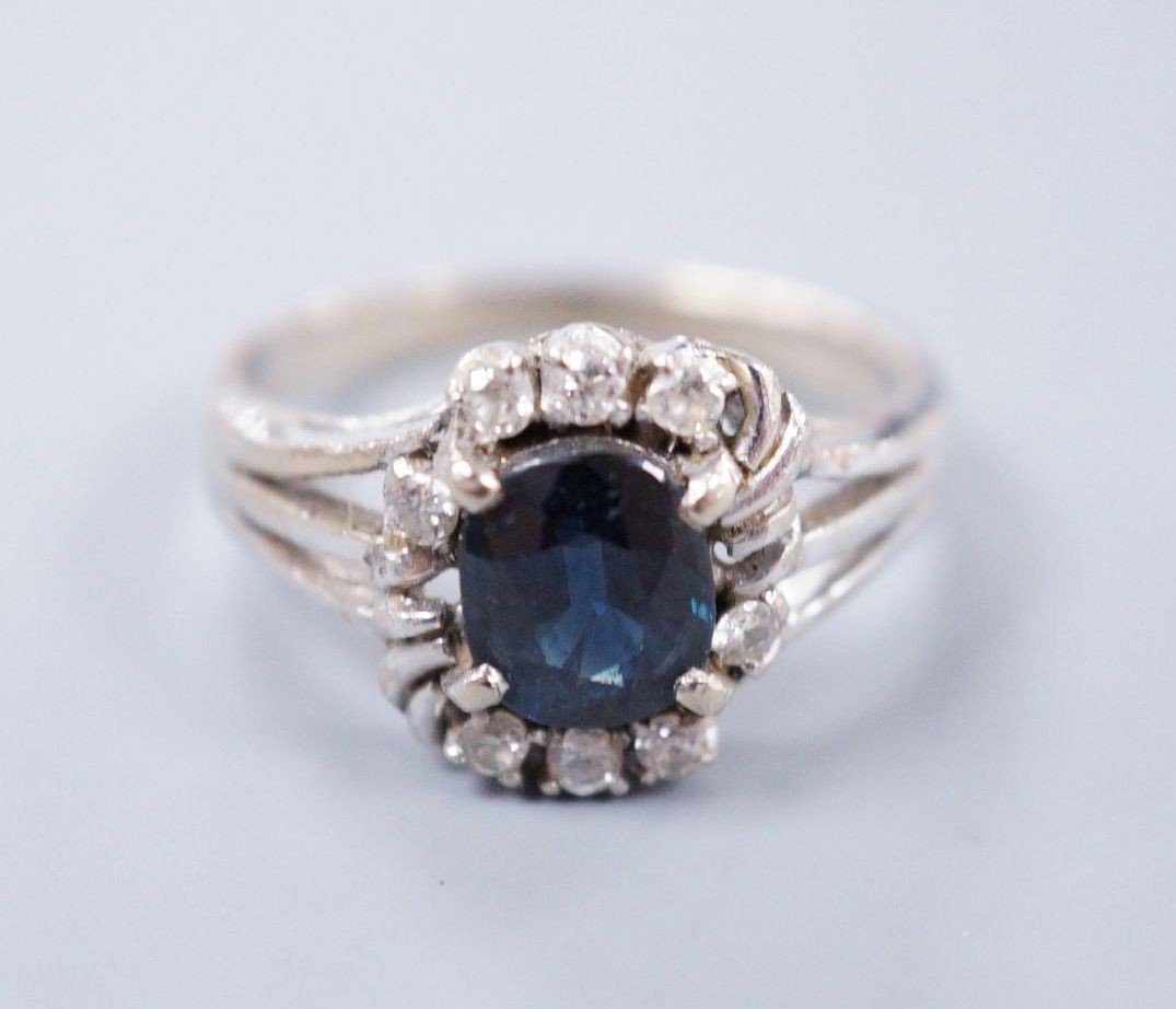 An 18ct white gold sapphire and diamond dress ring, size I