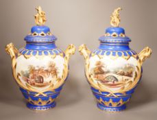 A pair of English bone China lidded two-handled vases, painted with river landscapes, within blue