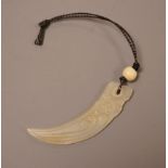 A Chinese jade tooth shaped pendant with bone bead