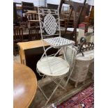 A painted metal circular folding garden table, diameter 60cm, height 68cm together with two