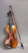 A quarter size late 19th century violin with bow, in E. Hill & Sons case, back measures 29cm Ivory