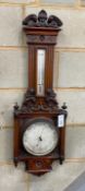 A late Victorian carved walnut aneroid barometer and thermometer, height 95cm