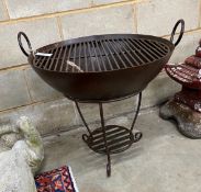 A circular wrought iron fire pit on stand, diameter 64cm, height 63cm
