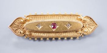 An Edwardian gold brooch, set with a ruby and two diamonds, 4.5cm gross 6.2 grams (a.f.)