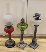 A Victorian plated oil lamp with glass reservoir, together with two others