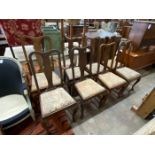 A set of eight early 20th century Queen Anne style mahogany dining chairs, one with arms