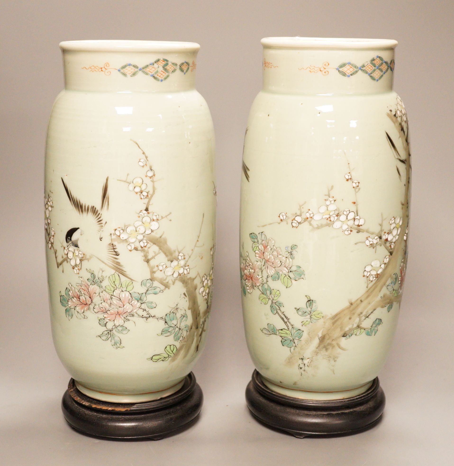 A pair of 19th century Japanese celadon glazed vases (drilled) with hardwood stands, total height