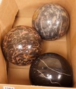 A trio of carved marble balls, largest 14.5cm