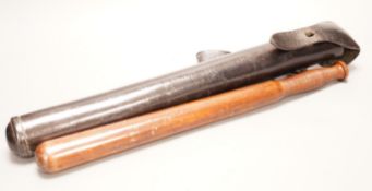 A 19th century constabulary truncheon together with associated spring loaded leather case