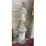 A reconstituted stone garden statue of Grecian lady wearing flowing robes, on a circular fluted