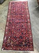A North West Persian blue ground hall carpet, 304 x 127cm
