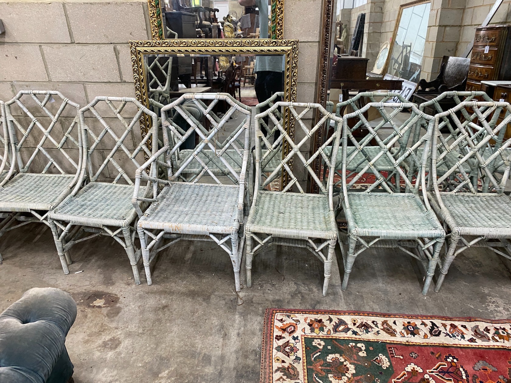 A set of ten white painted caned bamboo conservatory chairs with cockpen backs, two with arms