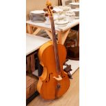 A cello and bow, back measures 73cm