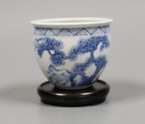 A Chinese blue and white ‘eight horses’ brush pot on wooden stand, 8cm tall including stand