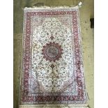 A Tabriz ivory ground part silk rug with central floral medallion, 150 x 95cm