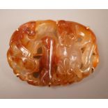 A Chinese carved agate plaque, Qing dynasty, later mounted as a brooch, 5.5cm long