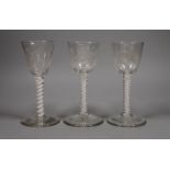 Three 18th century Jacobite type double series opaque twist stem wine glasses, 15cm tall