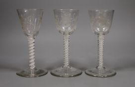 Three 18th century Jacobite type double series opaque twist stem wine glasses, 15cm tall