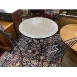 A circular mosaic top wrought iron garden table, diameter 100cm, height 74cm together with four