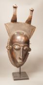 A West African tribal mask, possibly Baule, on stand, 47cm total