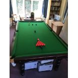 An early 20th century mahogany three quarter size snooker table on six turned tapered legs,