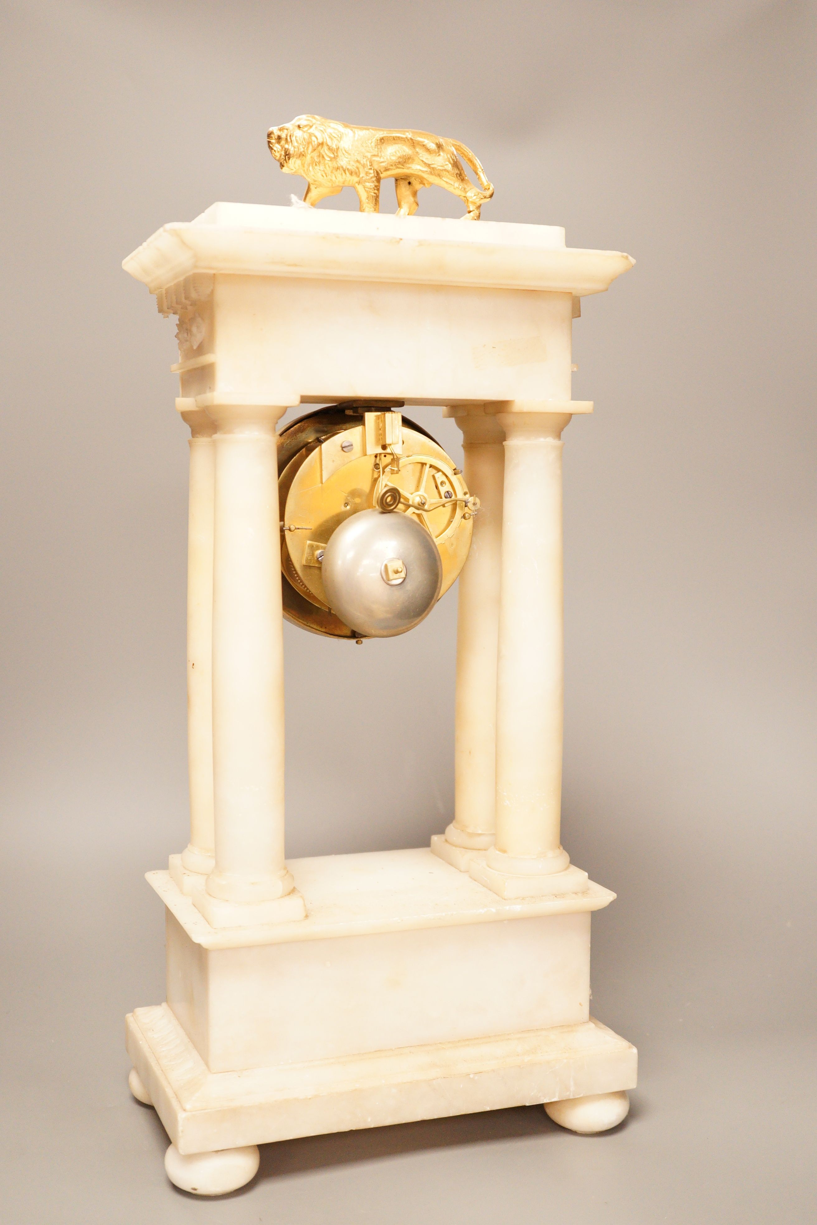 A 19th century alabaster portico clock with a gilt metal prowling lion decoration, 50cm tall - Image 3 of 5