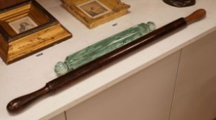 A Victorian glass rolling pin together with a turned wooden example, widest 82cm (2)