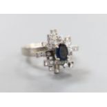 A modern 18k, sapphire and diamond cluster set dress ring, size K, gross weight 6 grams.