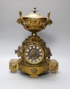 A French gilt metal mantel clock, designed with ornate vines and an urn,38 cms high,