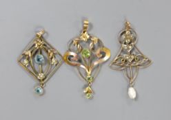 Three assorted Edwardian yellow metal and gem set pendants, including a 9ct and three stone peridot,