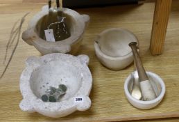 A collection of white marble and other mortars together with glass and other pestles (qty),largest