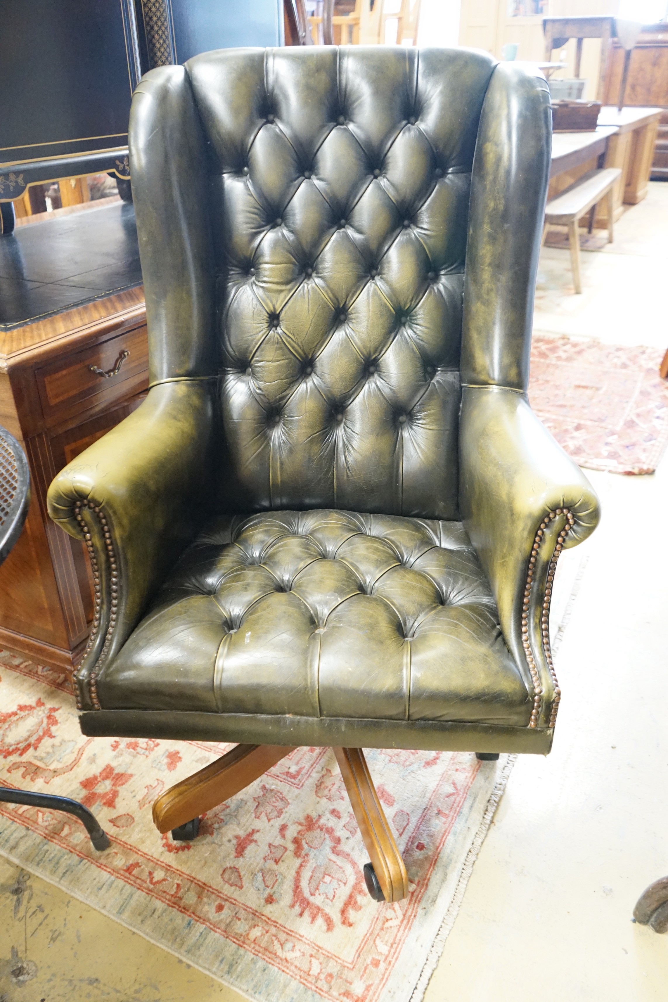 A Victorian style buttoned green leather swivel desk wing armchair, width 78cm, height 120cm - Image 2 of 2