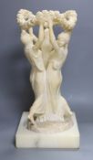 An alabaster carving of the Three Graces on associated base, 47cm total height