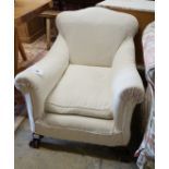 A 1920's upholstered mahogany club armchair on ball and claw feet, width 74cm, depth 86cm, height