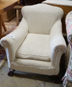 A 1920's upholstered mahogany club armchair on ball and claw feet, width 74cm, depth 86cm, height