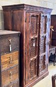 An Eastern carved hardwood two door cabinet, width 119cm, depth 67cm, height 192cm