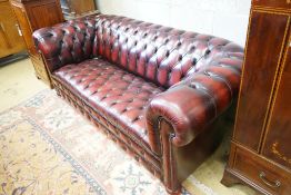 A Victorian style buttoned burgundy leather Chesterfield settee, length 200cm, width 90cm, height