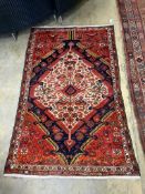 A Persian red ground rug, 196 x 123cm