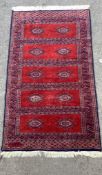 A Bokhara red ground rug, 160 x 93cm