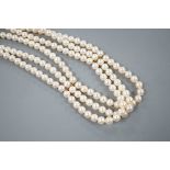 A triple strand cultured pearl necklace with 750 yellow metal clasp, 32cm.