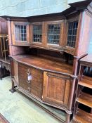 An early 20th century Arts & Crafts copper mounted oak sideboard in the manner of Shapland and