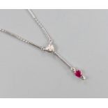 An 18ct white gold (750) pendant with ruby drop on bar and long link chain with silver clasp,