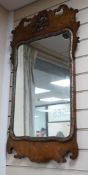 An 18th century style walnut fret cut wall mirror width 43cms height 93cms