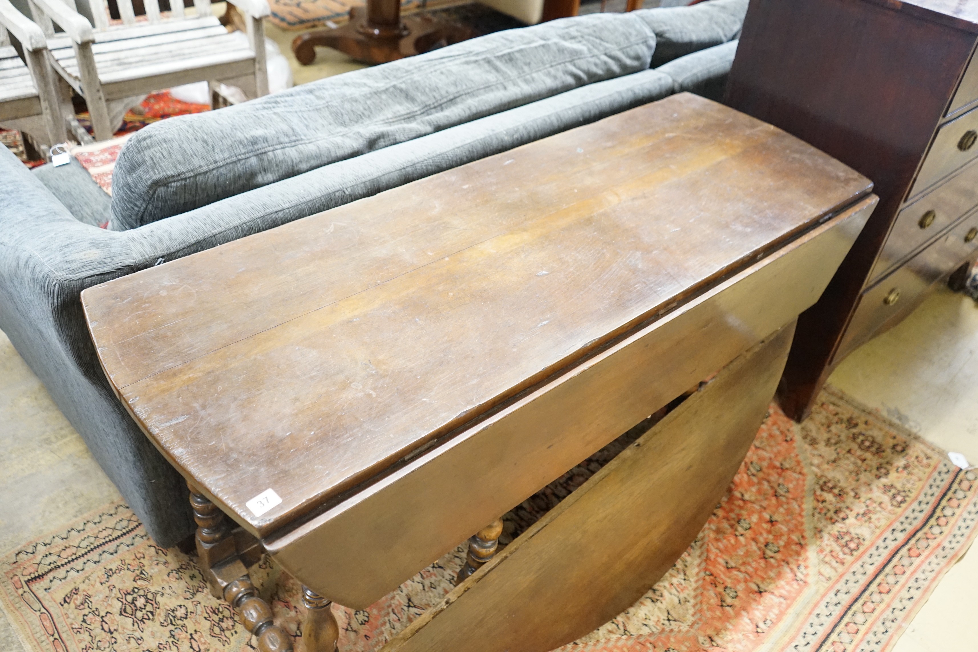 An early 18th century style oak oval topped gateleg dining table, (one leaf in need of repair), - Image 4 of 5