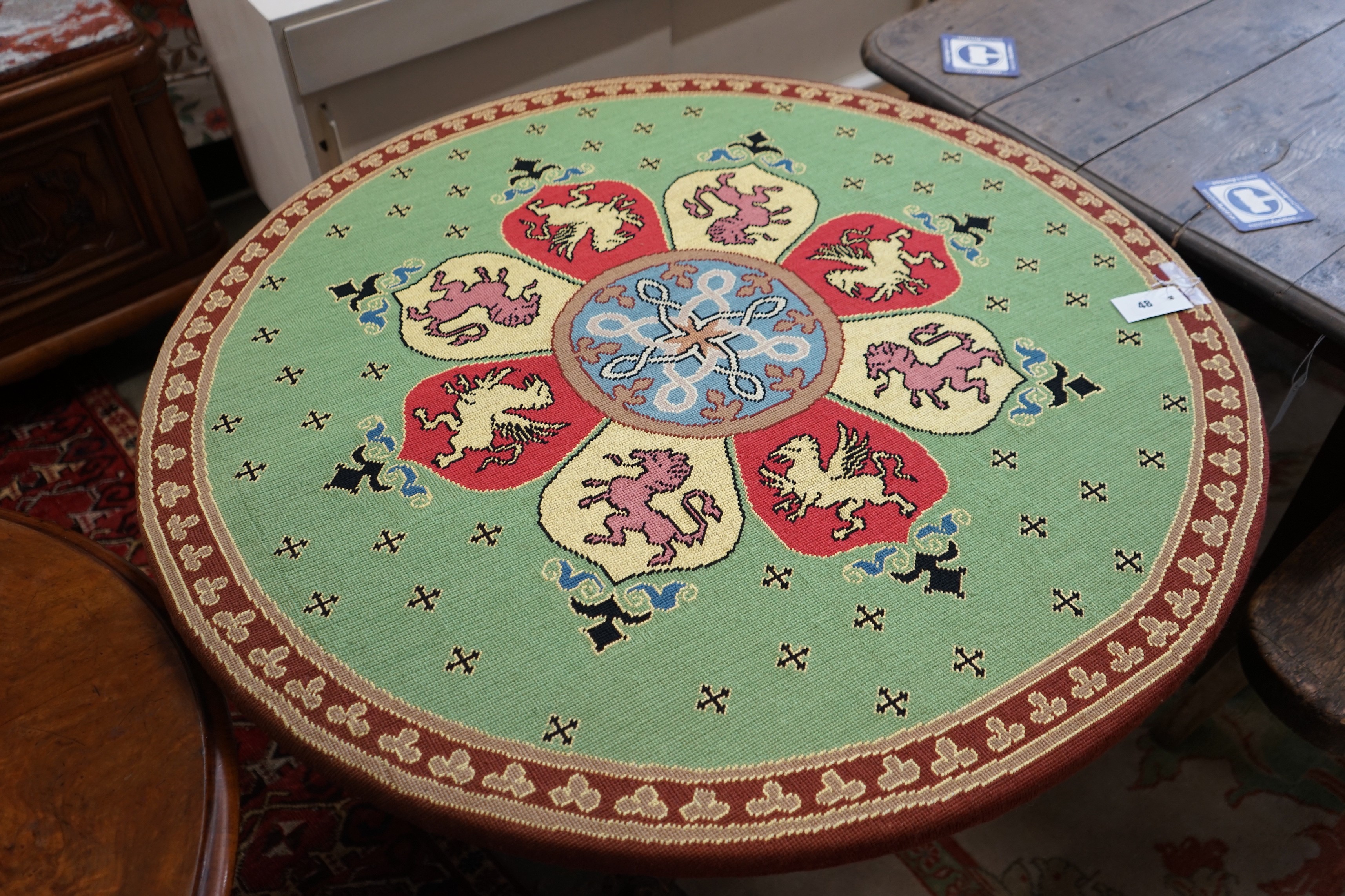 An early 20th century Continental carved oak circular centre table with heraldic tapestry top on - Image 4 of 4