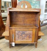 An Arts and Crafts oak wall cabinet, width 66cm, height 76cm