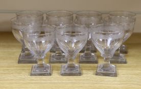 A set of twelve early 19th century engraved wine glasses, square foot, 11cm tall