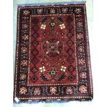 A Caucasian geometric red ground rug, 150 x 115cm